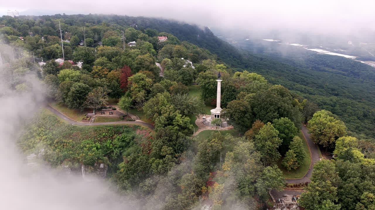 Fog drifts across Lookout Mountain as the Point Park monument emerges through the clouds, surrounded by lush Tennessee forest