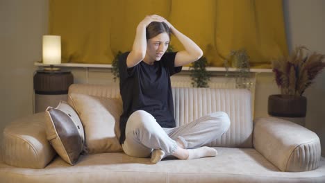 desperate young woman with her hands on her head. depressed.