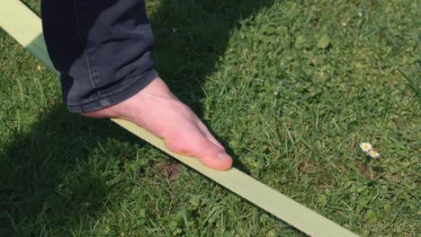 man find balance on slack line