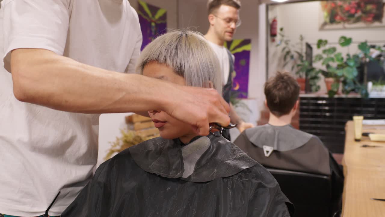 Hairdresser giving a customer a haircut