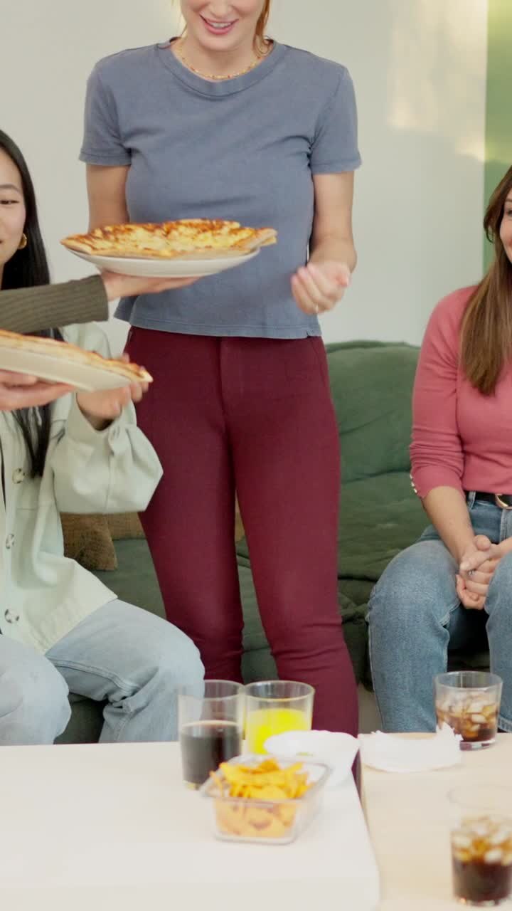 Woman arriving with take away pizzas at home with friends