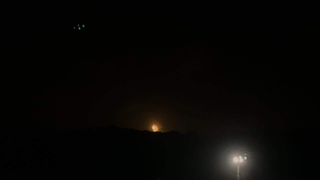 밤 큰 보름달이 언덕 위에서 하늘로 떠오른다