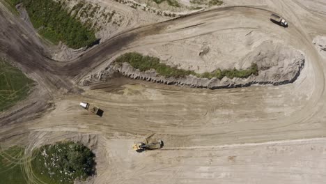 top down aerial shot of heavy equipment working on a dirty construction job site