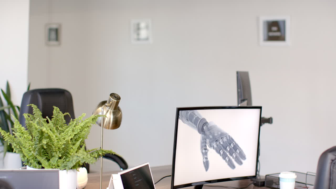 Displaying robotic hand on computer monitor in modern office workspace, copy space