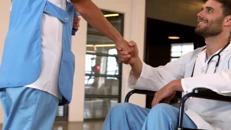 doctor on wheel chair handshaking