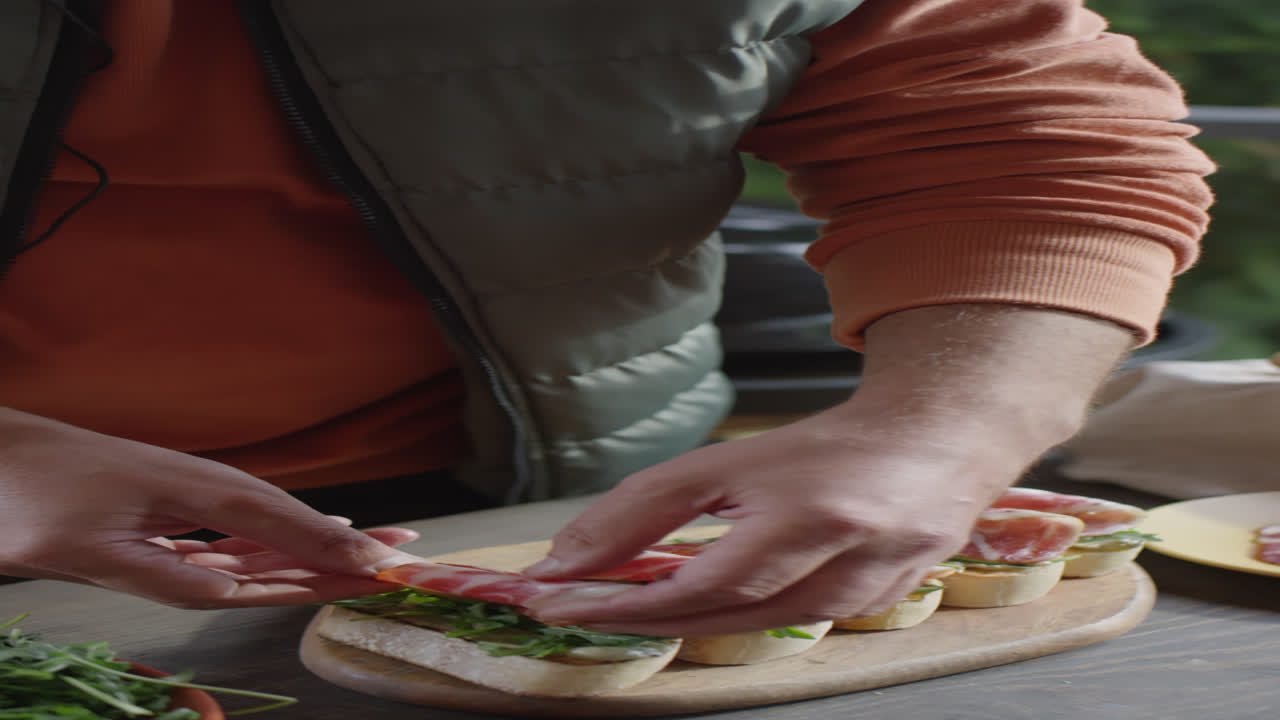Chef Preparing Bruschettas with Meat