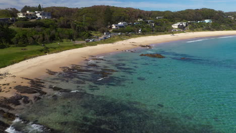 Seal-Rocks-beach-on-sunny-Australian-coastline,-aerial-view