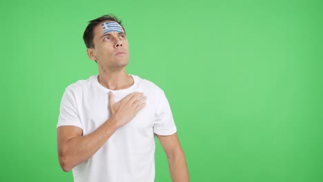 Man listening to the Greece national anthem with solemnity