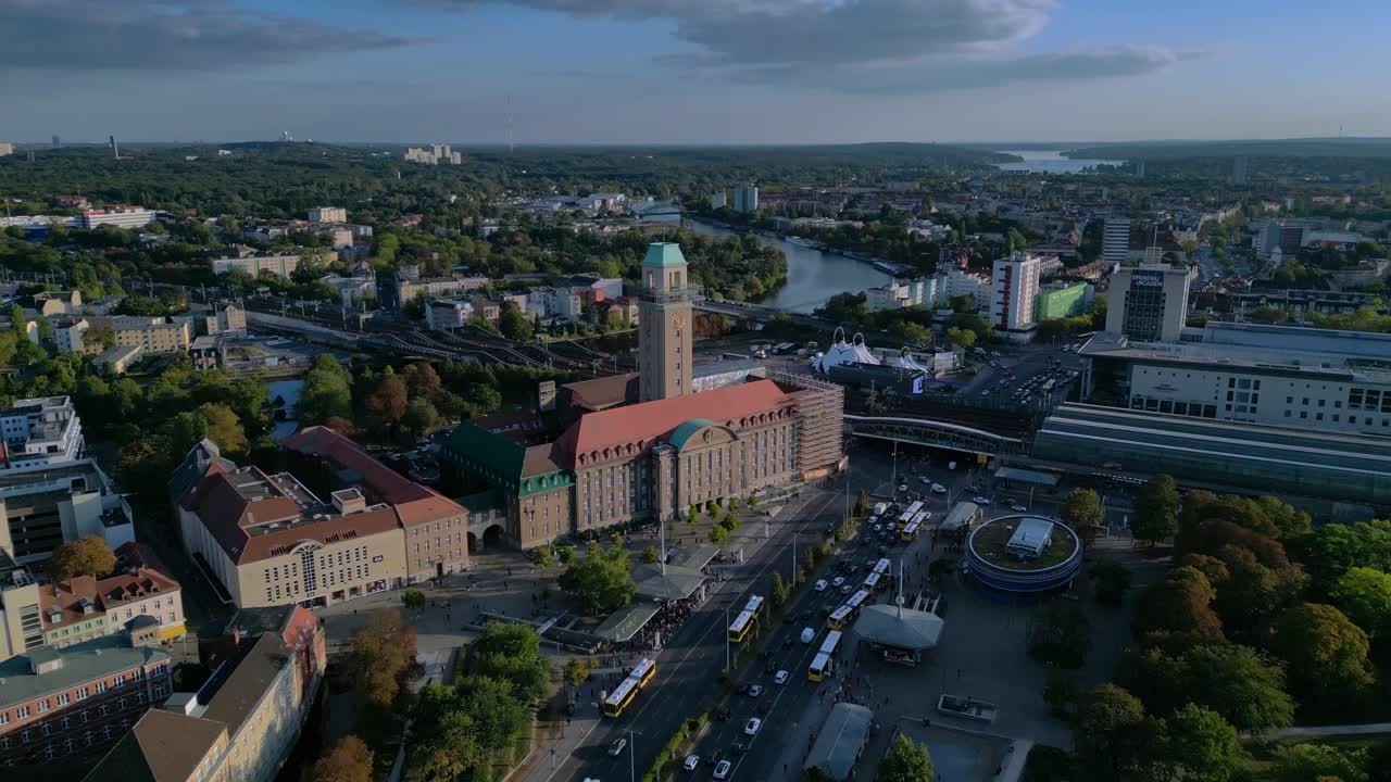 Aerial view showing Rathaus Spandau building, subway station, and public transportation in Berlin. Nice aerial view flight fly reverse drone