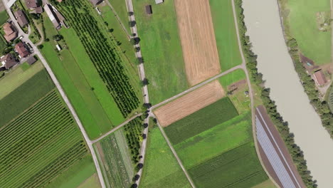 aerial view of a farm with fields and a river