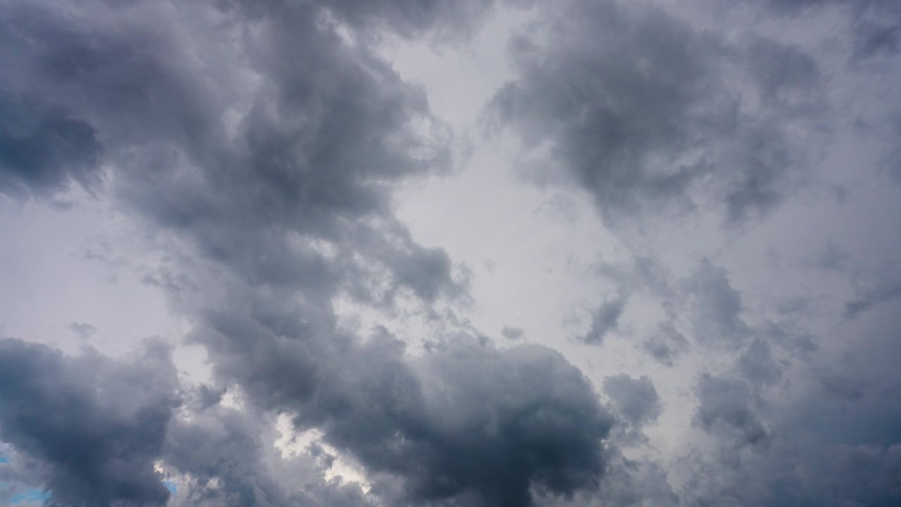 Clouds drifting across a moody stormy sky above