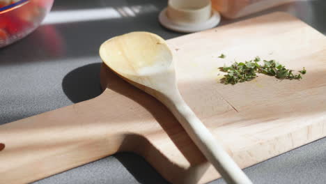 chopped oregano on a wooden board in the summer sunlight