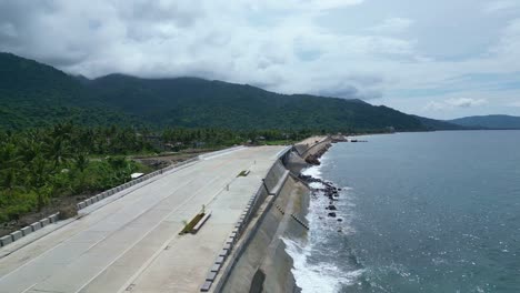 Aerial-footage-of-a-construction-site-near-the-ocean,-preparing-for-rising-sea-levels-due-to-climate-change