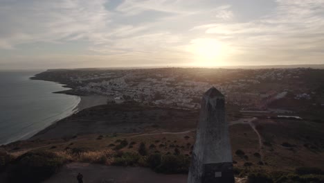 Panoramic-of-Gold-Sunset-over-Praia-da-Luz-Townscape,-Algarve---Aerial