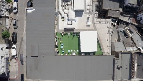 aerial rises over rooftop patio on building in archway district london