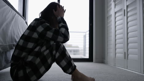 woman sitting on floor in bedroom