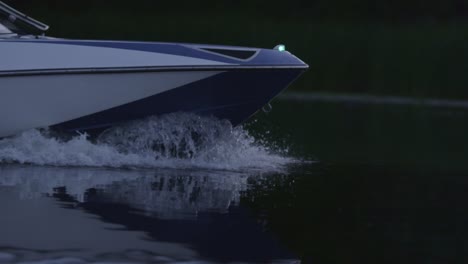 Speedy-motor-boat-floating-on-river-in-evening.-Boat-bow-cutting-water