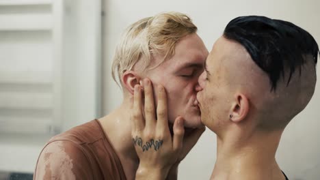 pareja gay abrazándose besándose en los labios de cerca