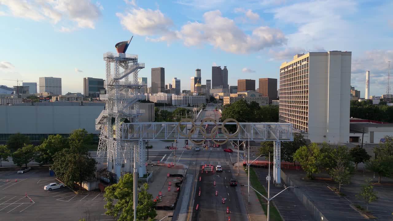 Static aerial shot of The 1996 Olympic Cauldron and downtown at sunset.