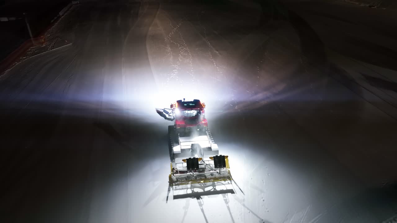 Snowcat vehicle driving over a snowfield