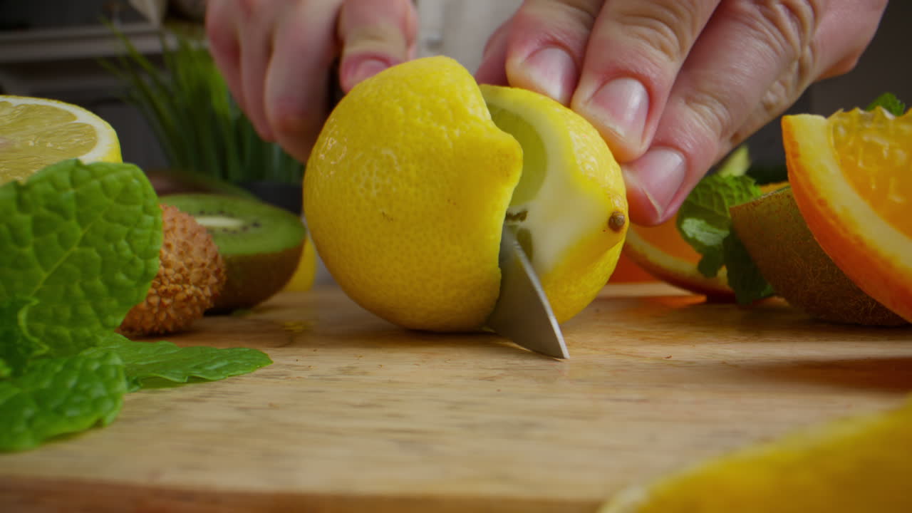 Cutting fresh fruit, preparing for a healthy beverage
