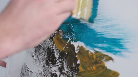 a talented man stands in front of an easel and paints an abstract picture a talented man stands in front of an easel and paints an abstract picture the talented artist enjoys the workflow in his creative studio creativity and art concept
