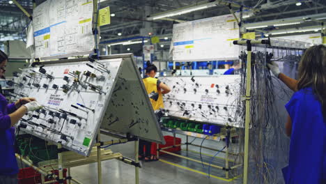 woman working on production line. beautiful young girl operates machine in the workshop production line