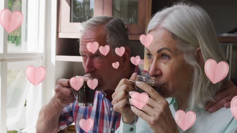 Animation-of-heart-icons-over-senior-couple-drinking-coffee