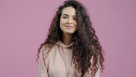 young woman with curly hair in a hoodie