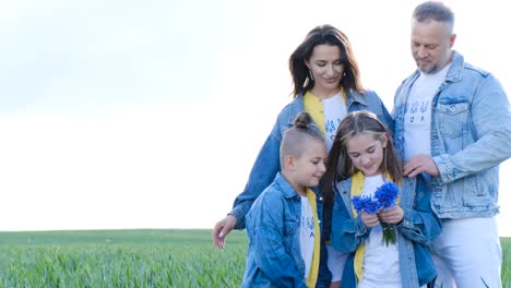 happy family are walking in the open green field happy family are walking in the open green field friendly family vacation together hiking in nature from a birds eye view people spend time carefree outdoors in the summer in a public park
