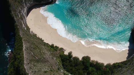 birds eye view shot of a beautiful blue ocean on a remote island in the tropical sun