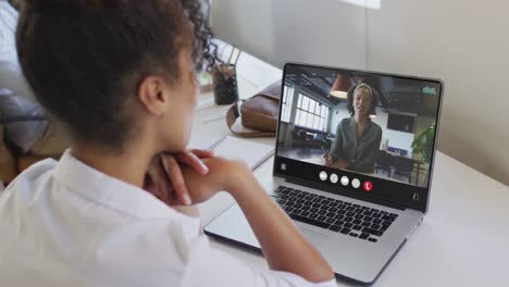 Animation-of-biracial-woman-having-video-call-on-laptop