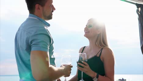 couple enjoying wine by the lake