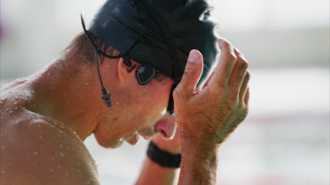 Focused Swimmer Preparing for Competition: Capturing the Intense Moment Before Diving into the Water, Showcasing Determination and Commitment to Excellence