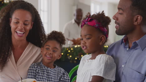 Multi-Generation-Family-Celebrating-Christmas-At-Home-With-Grandparents-Preparing-Meal-In-Kitchen