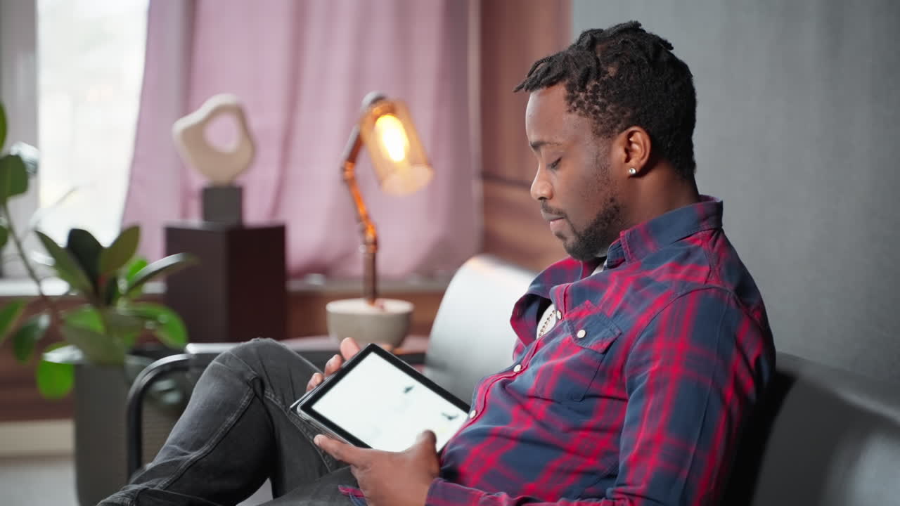 Man using tablet on a couch