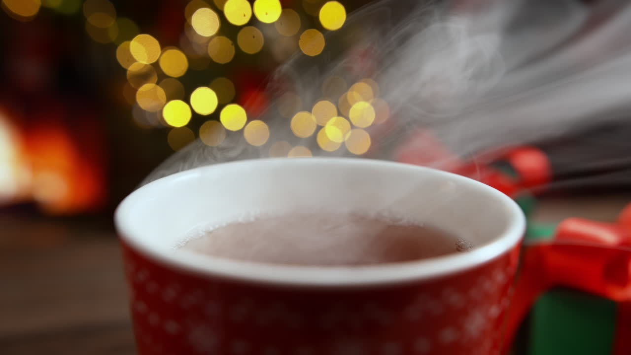 Cup Of Hot Steaming Tea On The Christmas Table With Presents By The Warming Fireplace