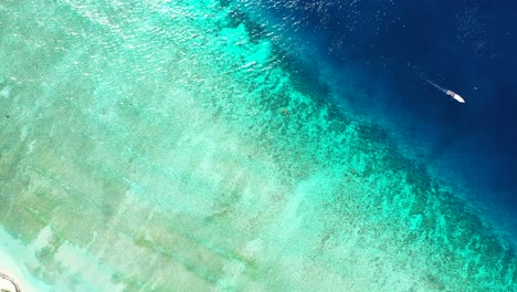 Beautiful-blue-turquoise-seaside-with-deep-sea-and-shallow-lagoon-with-coral-reefs-near-white-exotic-beach,-Malaysia