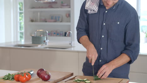 Man-Follows-Recipe-On-Digital-Tablet-In-Kitchen-Shot-On-R3D