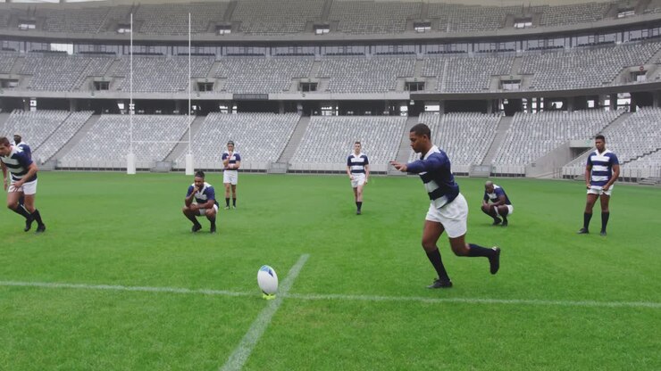 Male rugby player kicking rugby ball in ground at stadium 4k