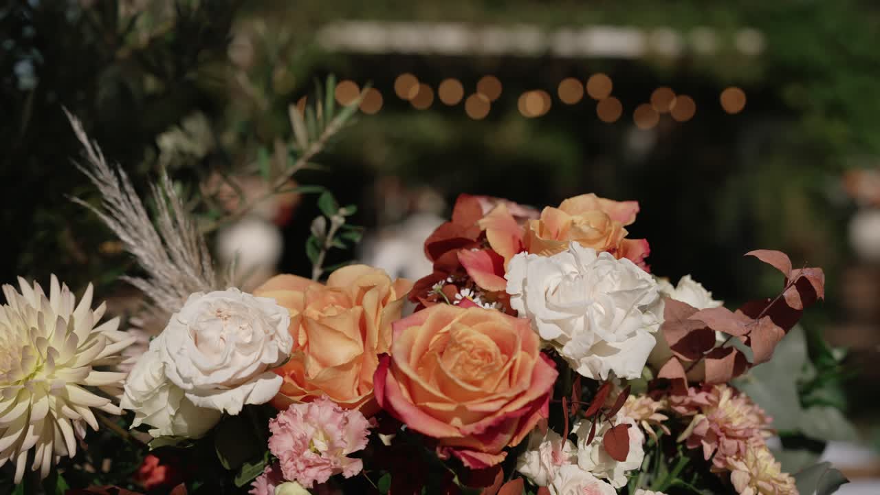vibrant floral bouquet with roses and pampas grass at dusk