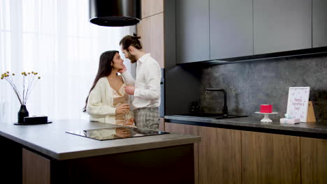 young couple kissing on the kitchen