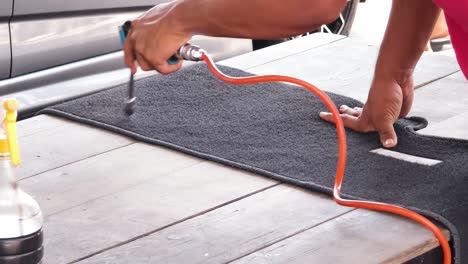 cleaning car mats on wooden table