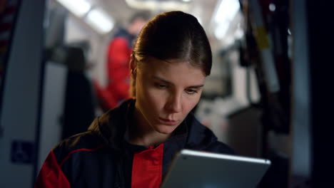 Paramedic-working-on-tablet-computer.-Pensive-woman-surfing-social-media-network