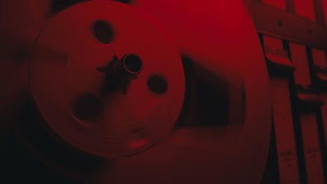 a close-up on a vintage tape recorder in a red blinking light