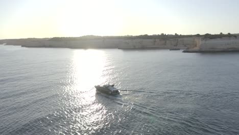 luxury yacht cruising along the dramatic coastline of the algarve