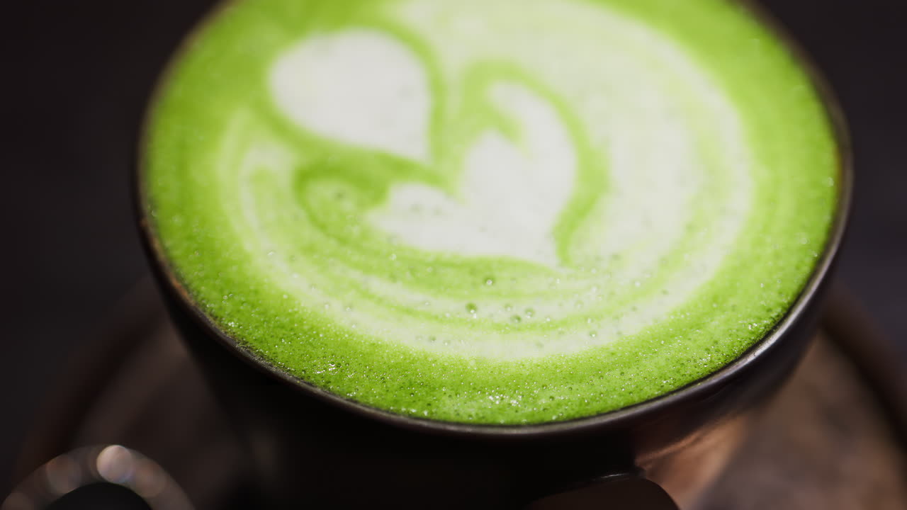 Close up of a matcha latte on a tray at a cafe