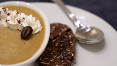 Closeup-of-coffee-bean-Custard-Dessert-with-whipped-cream-and-biscotti