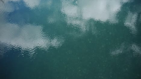 beautiful turquoise water surface reflecting a pretty sky in soft ripples