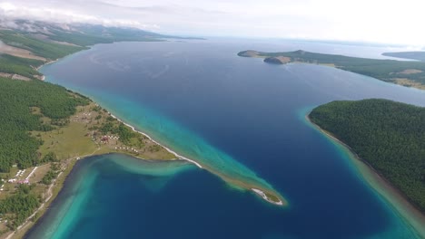 aerial drone shot moving forward over khuvsgul lake mongolia. sunny afternoon